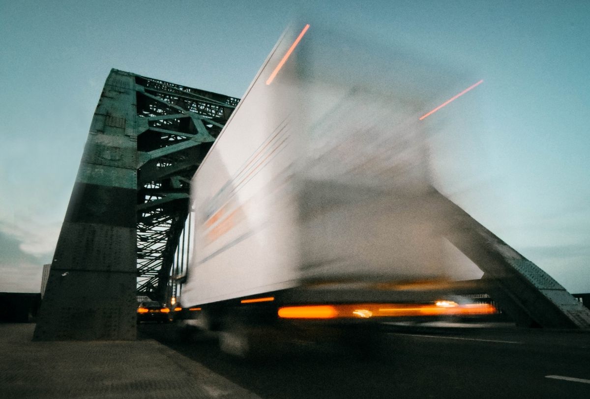 Freight truck crossing a bridge with motion blur